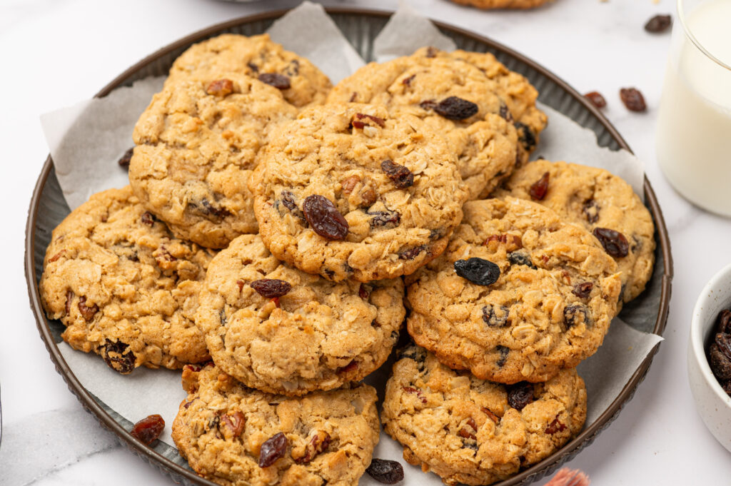 Brown Butter Oatmeal Raisin Cookies piled on a plate and served on a table.