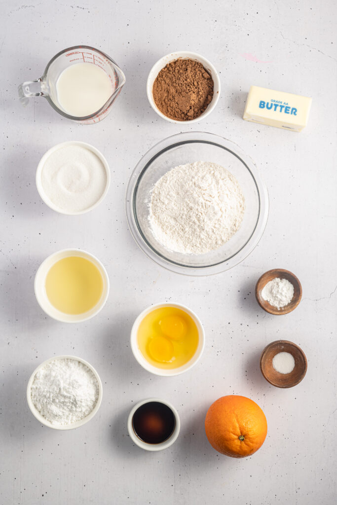 Ingredients for Chocolate Orange Cupcakes are laid out on a table.