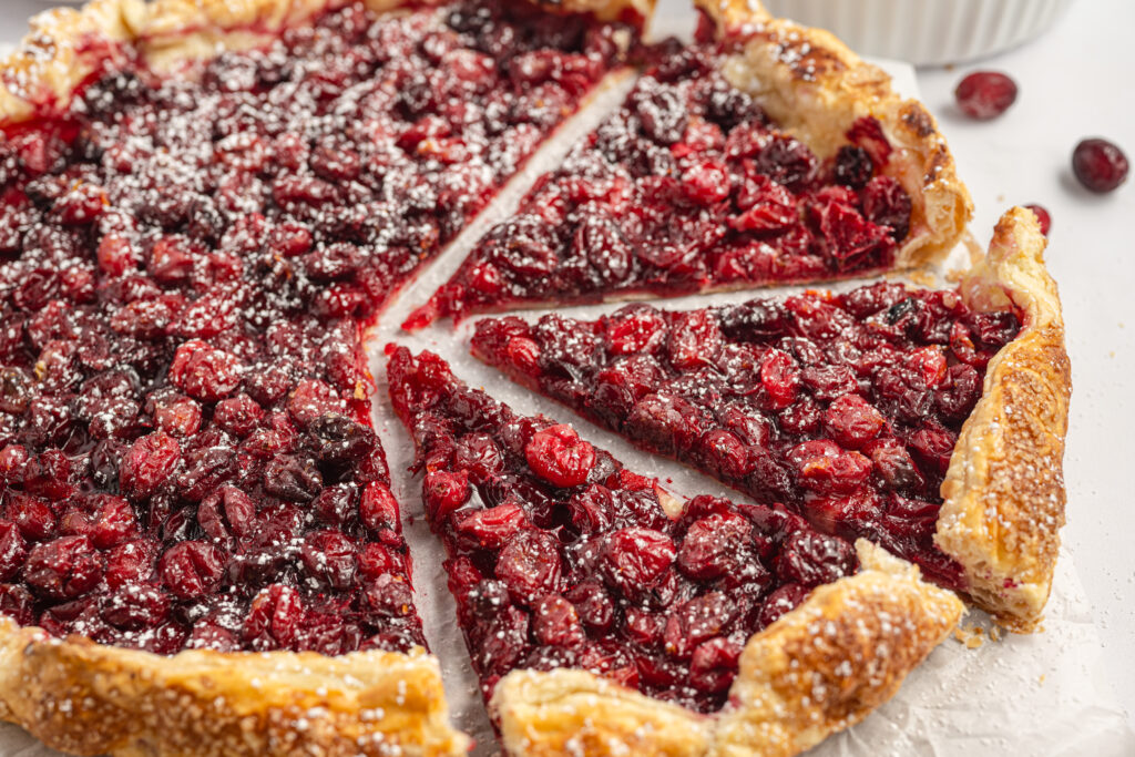 Cranberry Galette, sliced and served on parchment paper.