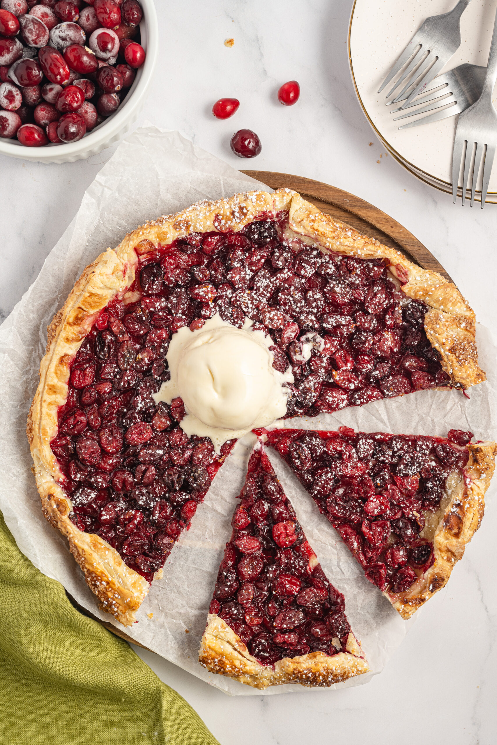 Cranberry Galette, sliced with a scoop of vanilla ice cream on top.