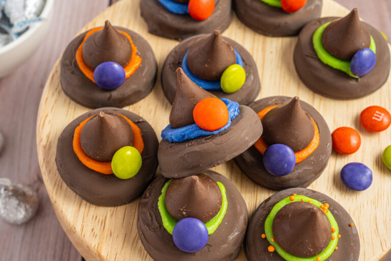 Peanut Butter Witch Hat Cookies piled on a small wood display.