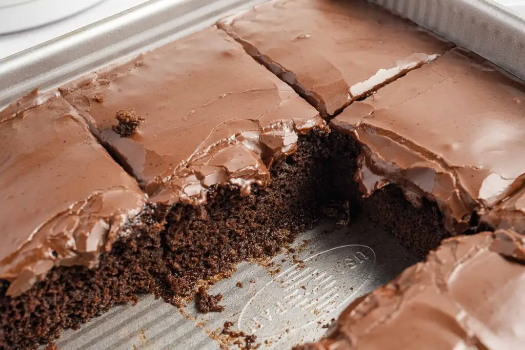Wacky Cake in a pan with slices missing.
