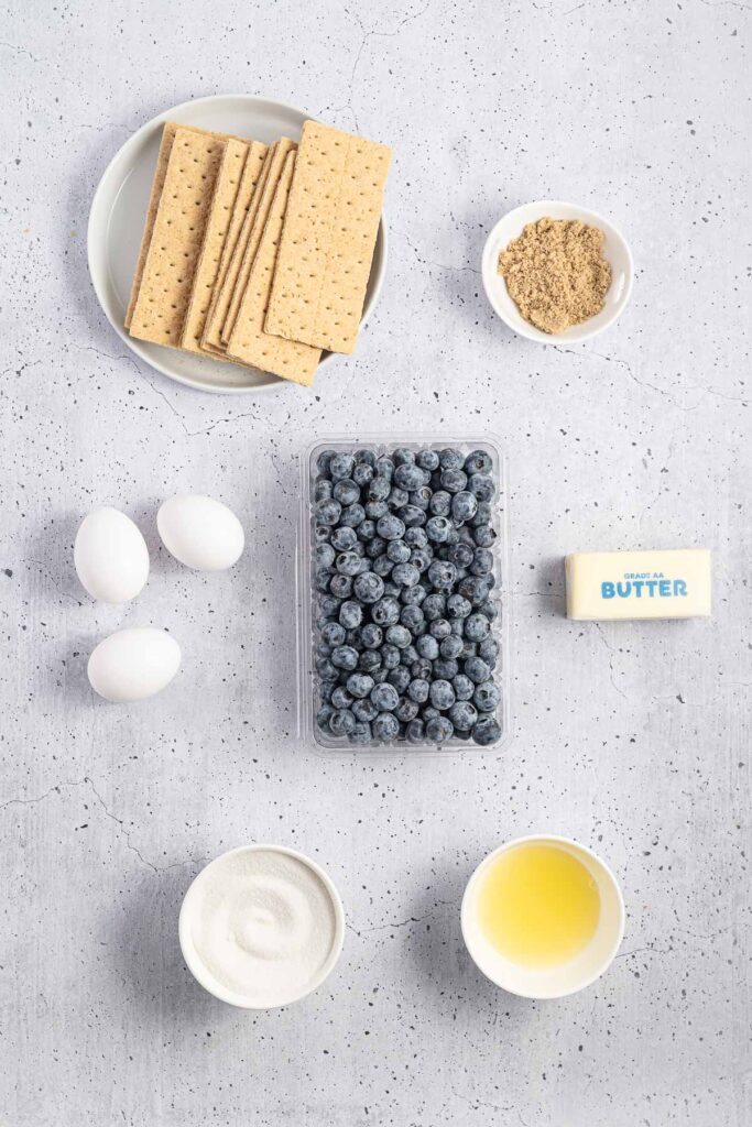 Ingredients for blueberry curd tart laid out on a table.