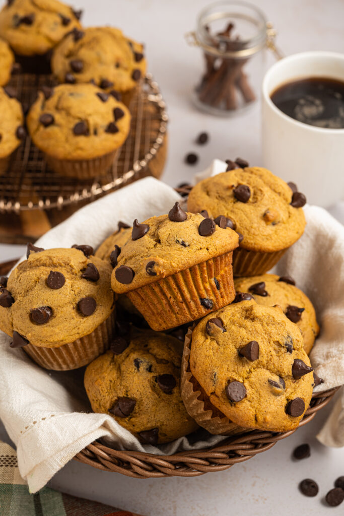 Chocolate Chip Pumpkin Muffins piled in a basket.