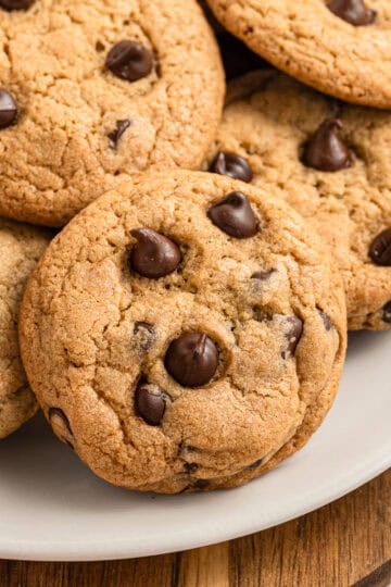 eggless chocolate chip cookies piled on a plate.