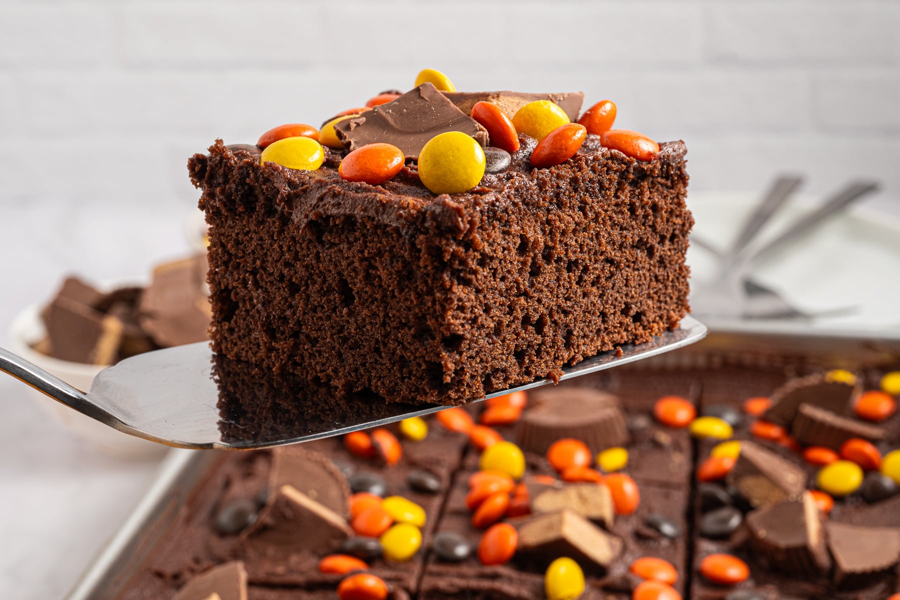 A slice of chocolate peanut butter sheet cake on a serving utensil